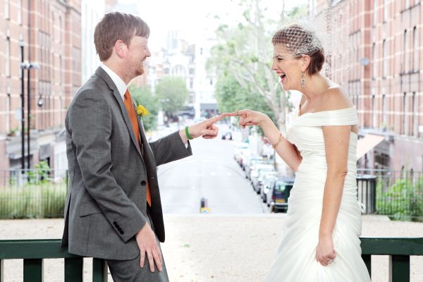 documentary wedding photography bride and groom celebrating getting married by touching fingers like Leonardo Di Vinci painting The Creation of Adam